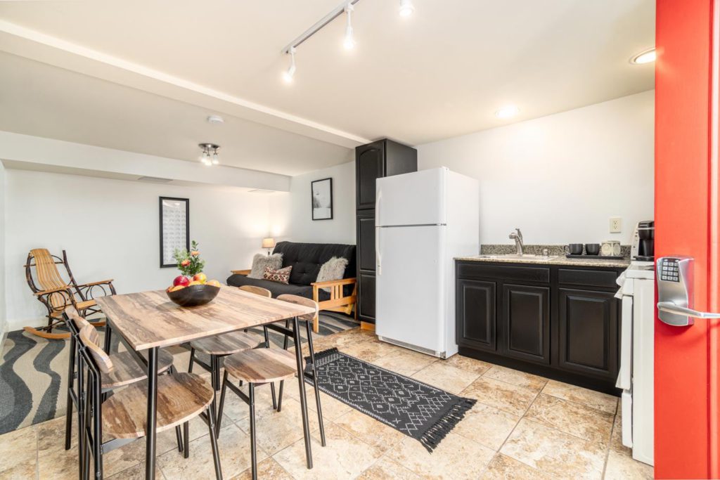 a kitchen with a table and chairs and a refrigerator
