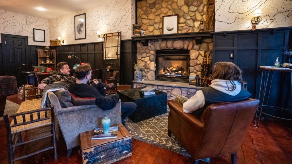 a group of people sitting around a hotel room