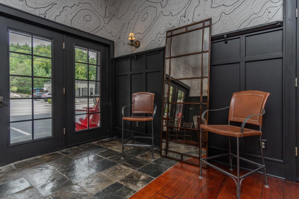 a room with two chairs and a mirror