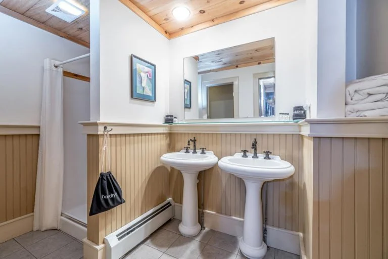 a bathroom with two sinks and a mirror