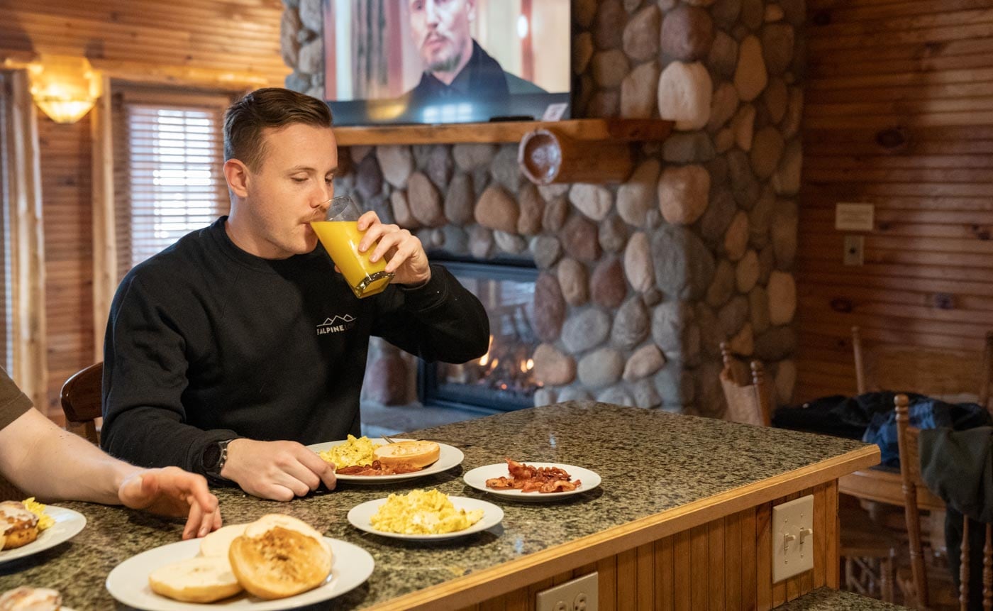 a man sitting at a table with plates of food