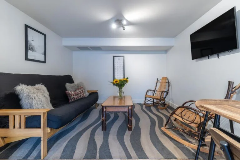 a hotel room filled with furniture and a flat screen tv