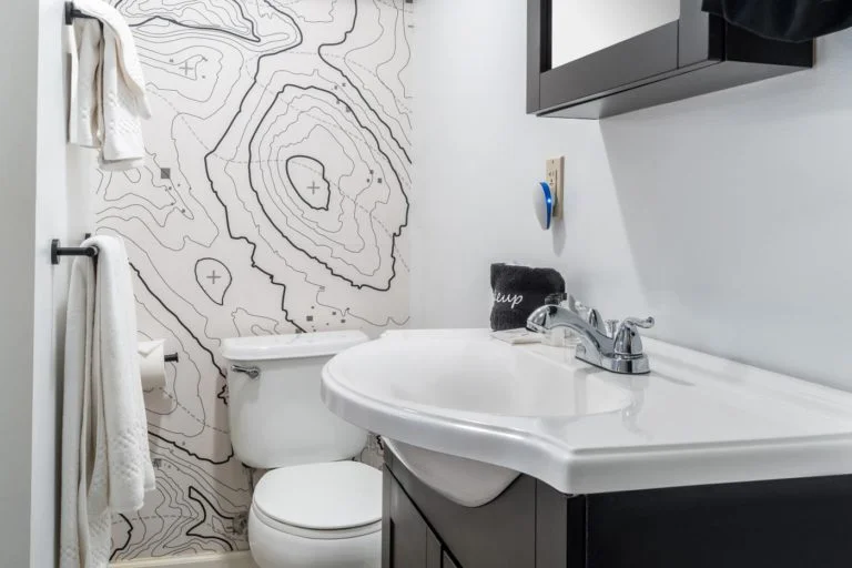 a white toilet sitting next to a white sink