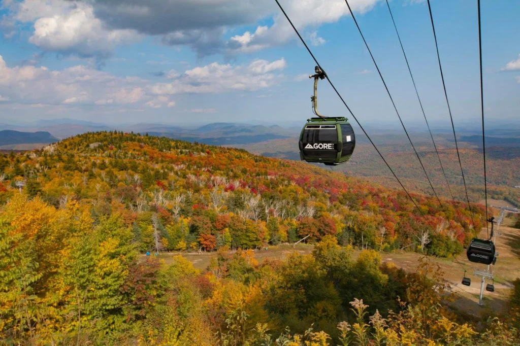 a gondola with a view of the mountains and trees