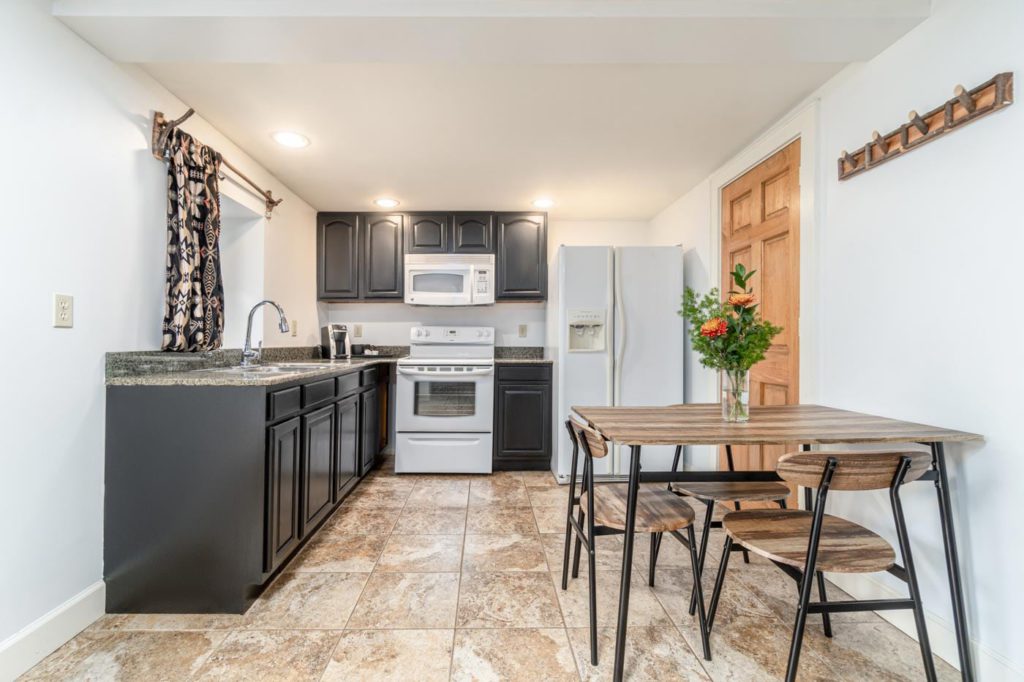 a kitchen with a table and chairs and a stove