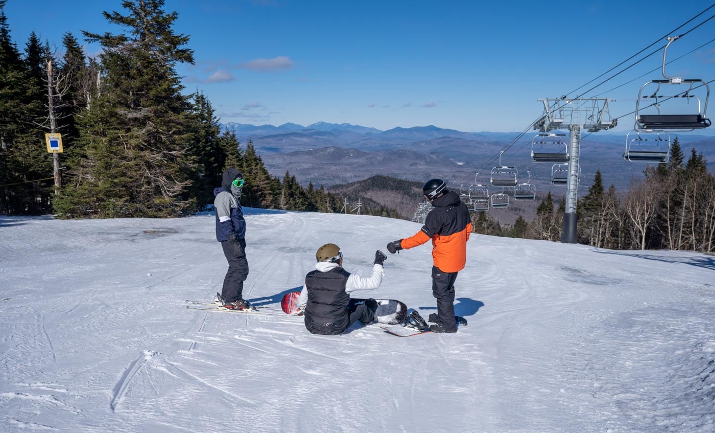 a group of people standing on top of a snow covered slope