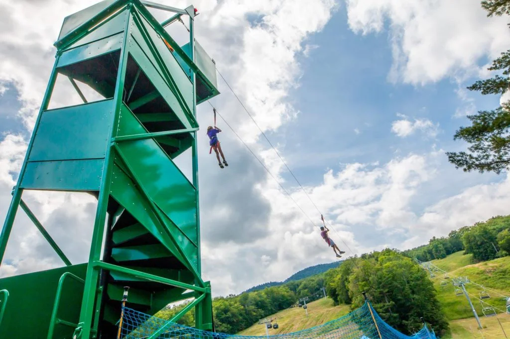 a person on a rope course in the air