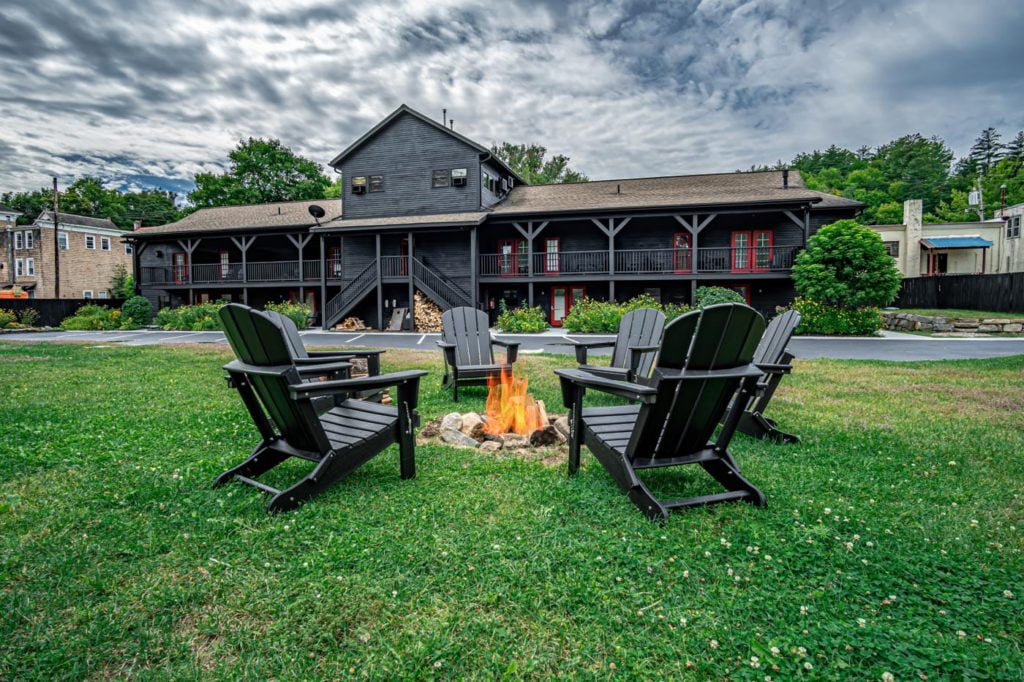 a couple of chairs sitting in front of a fire pit