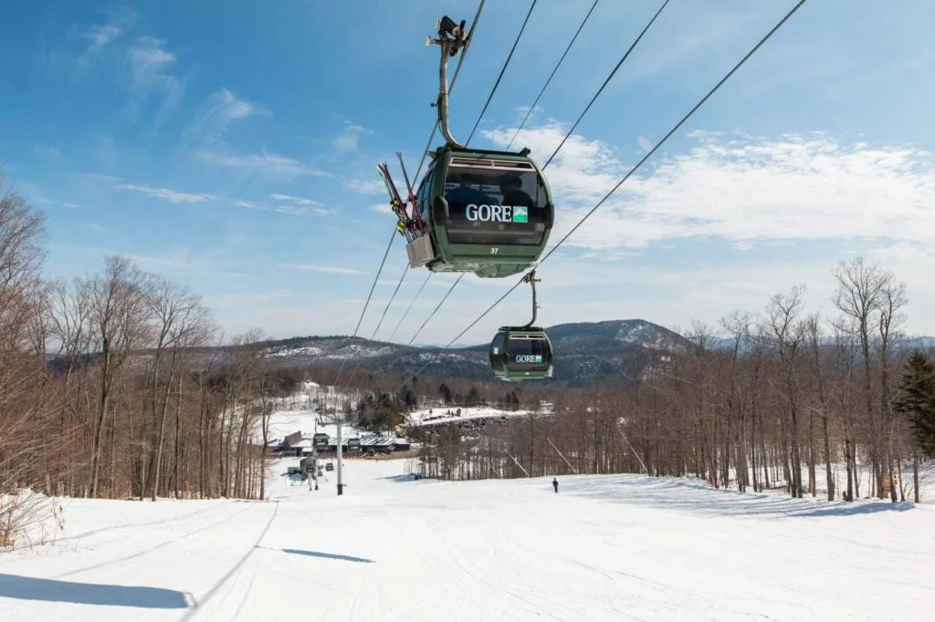 a ski lift that is above a snowy hill