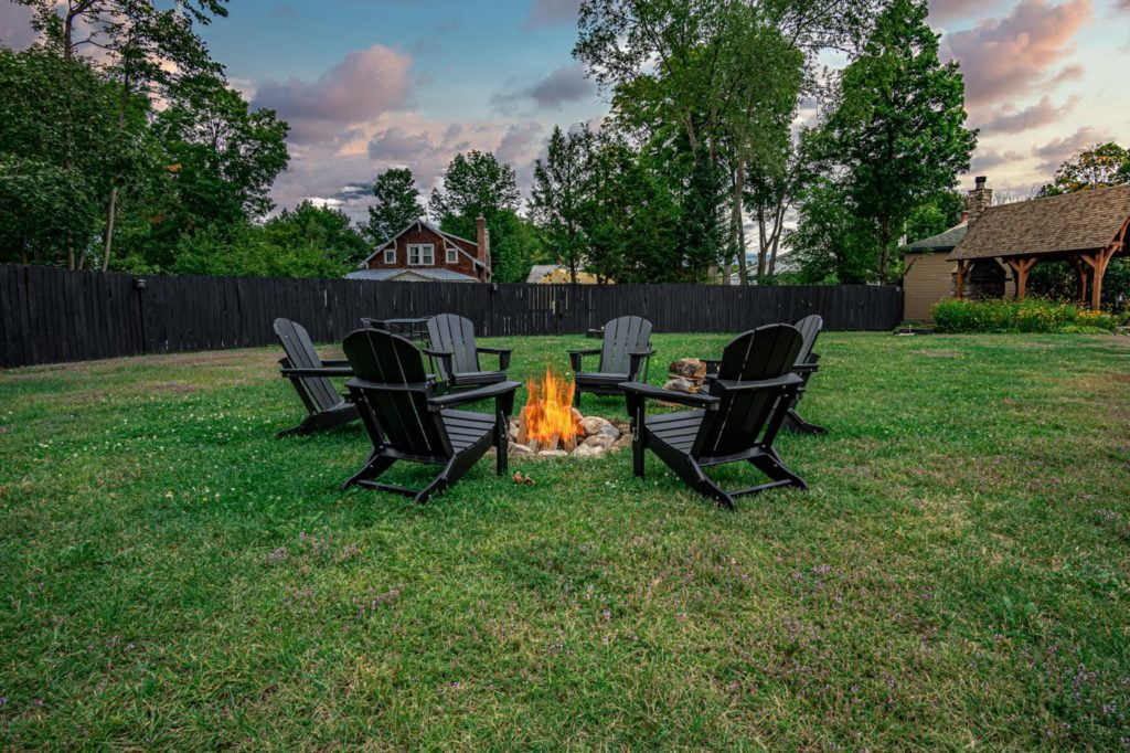 a group of chairs sitting around a fire pit
