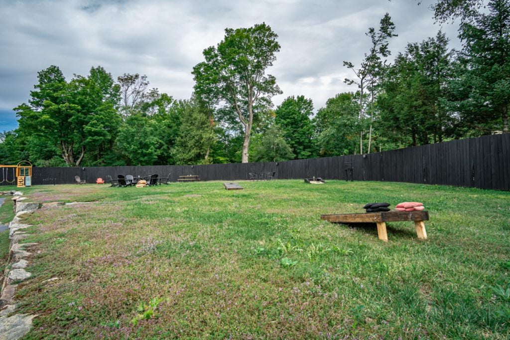 a backyard with a wooden bench in the middle of it