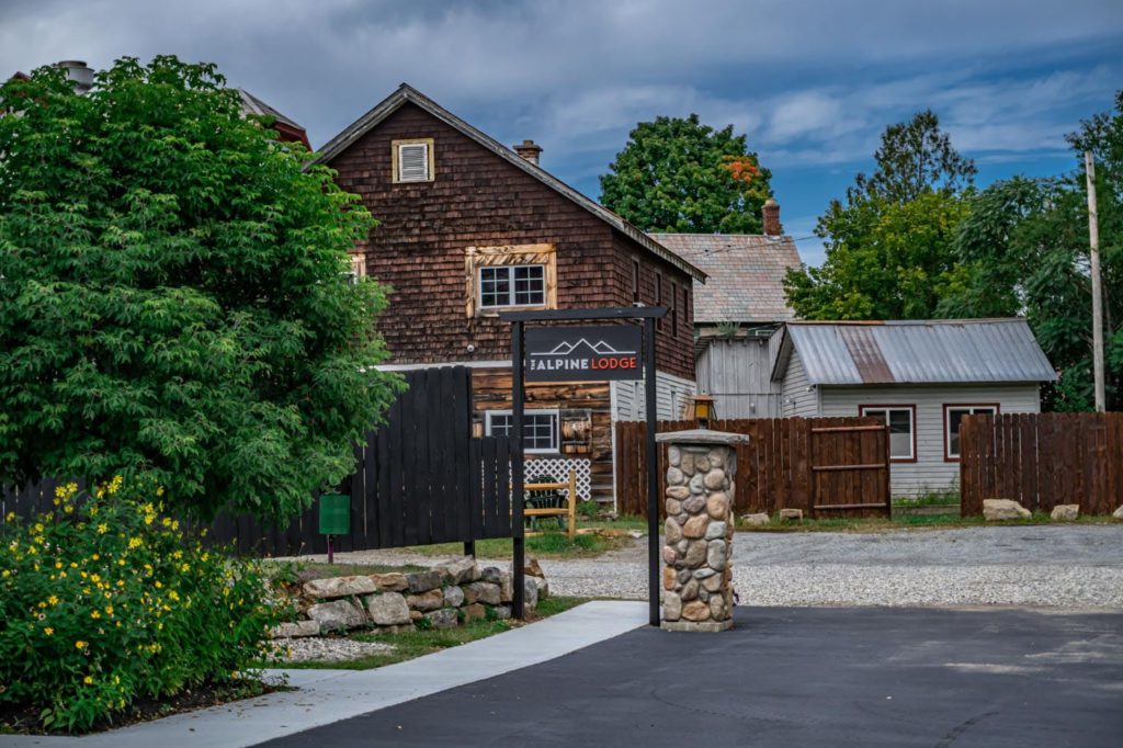 a wooden building with a sign in front of it
