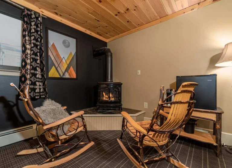 a hotel room filled with furniture and a fire place