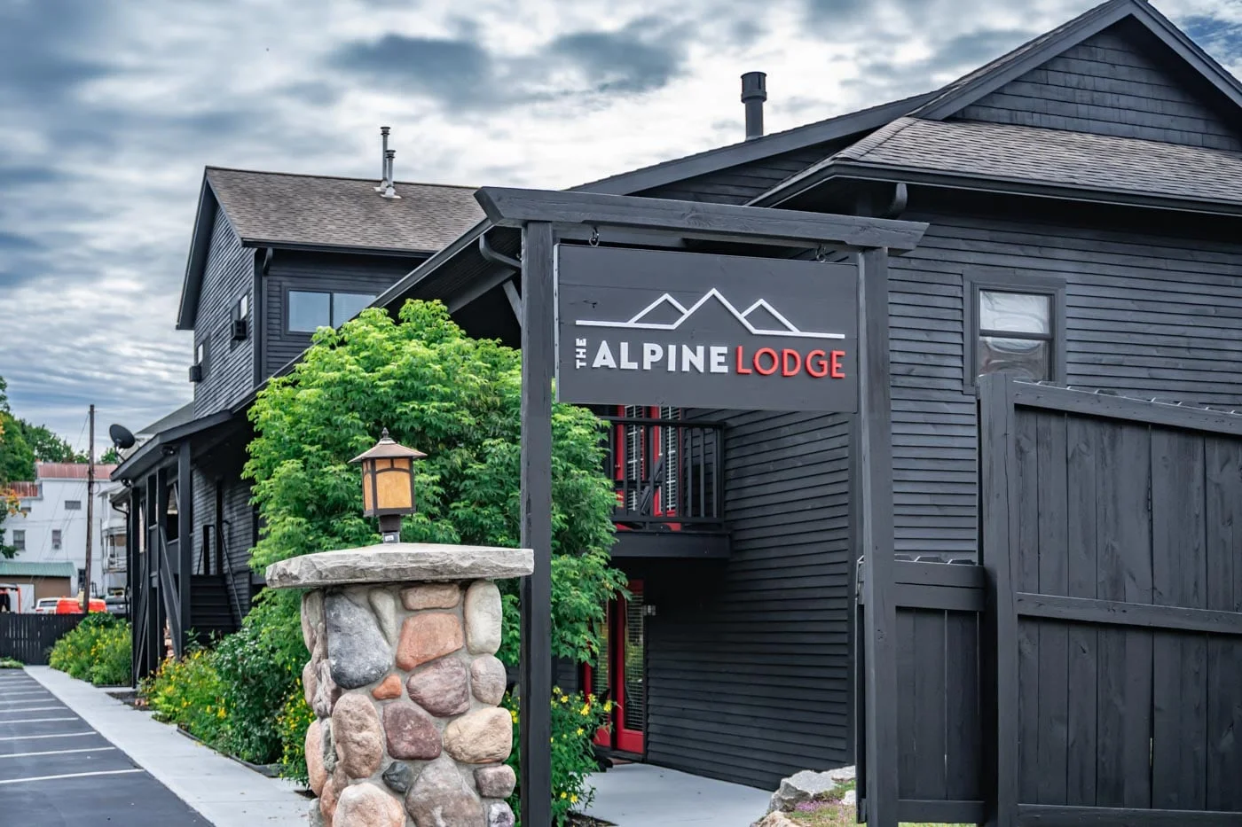 a black building with a sign that says alpine lodge