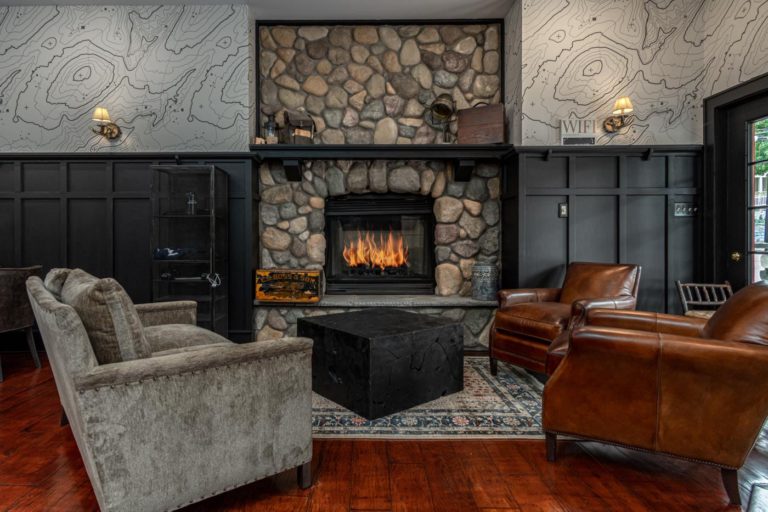 a hotel room filled with furniture and a fire place