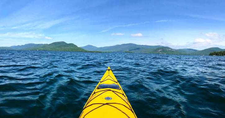 a yellow kayak in the middle of a body of water