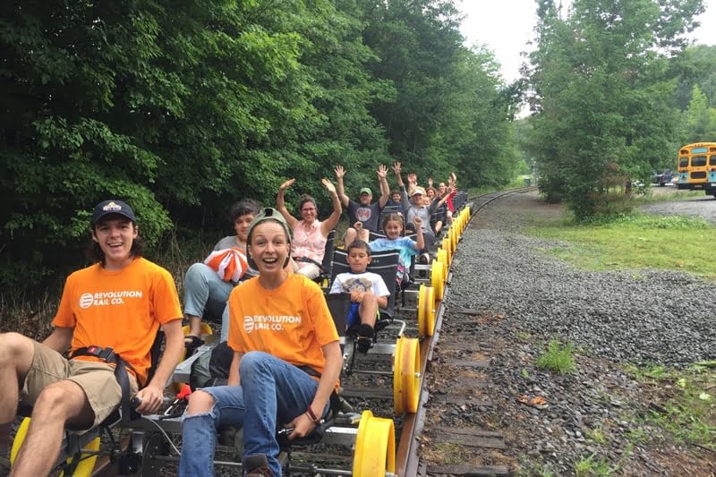 a group of people riding on the back of a train