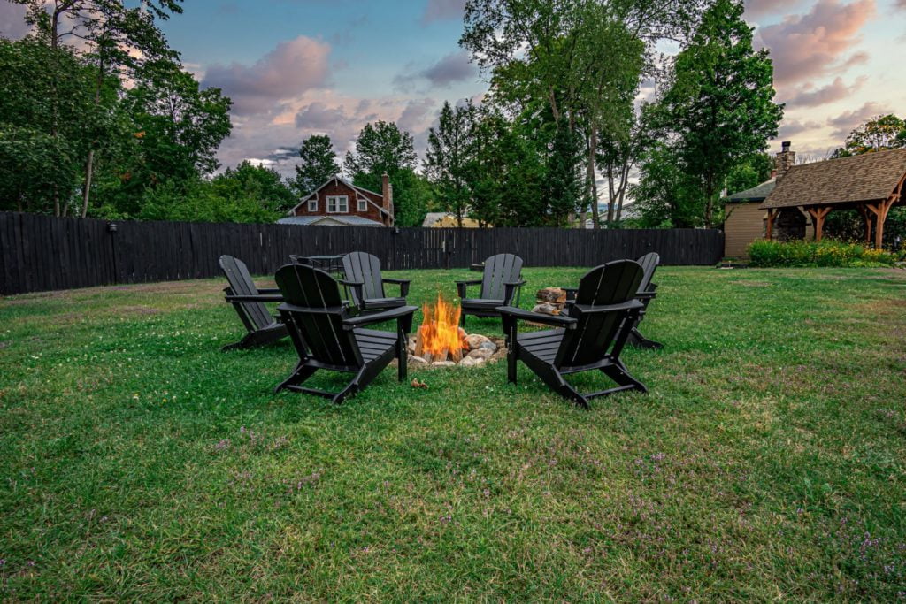 a group of chairs sitting around a fire pit