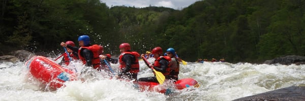 a group of people riding on top of a raft down a river