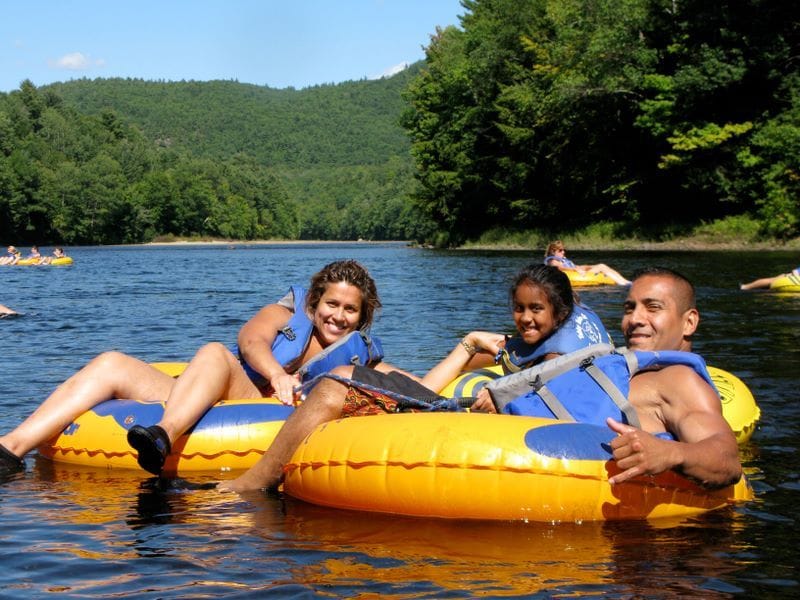 a group of people riding on top of an inflatable raft